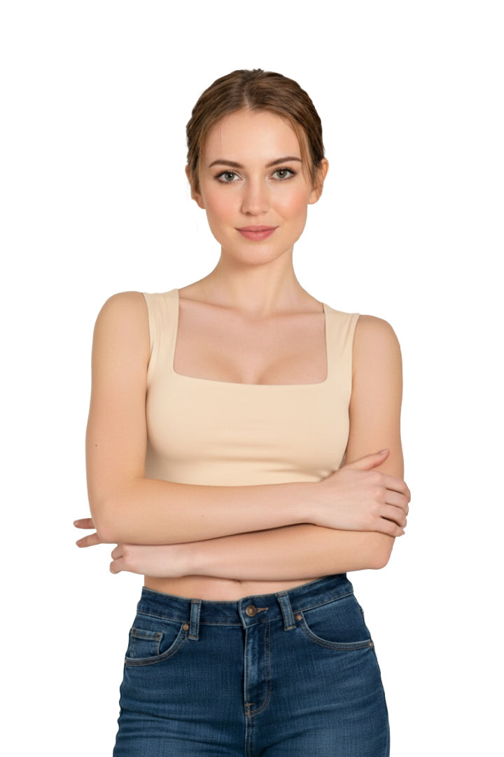 Front view of a woman wearing a beige square neck crop top paired with high-waisted blue jeans.
