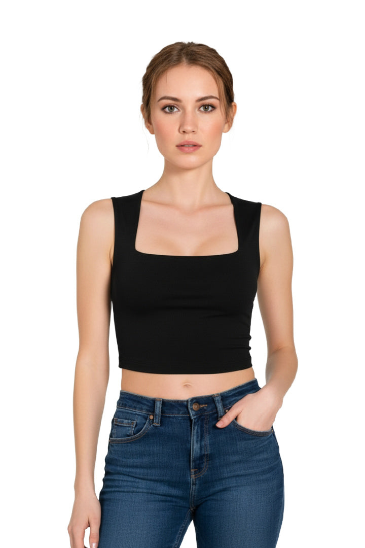 Front view of a woman wearing a black square neck crop top paired with high-waisted blue jeans.
